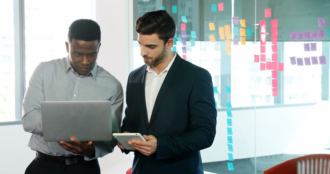 Diverse Team Collaborating at Modern Office with Laptop and Sticky Notes