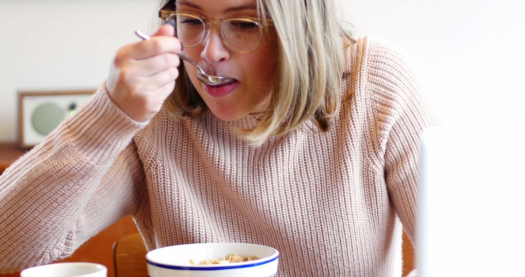 Woman Eating Breakfast Cereal at Home - Free Images, Stock Photos and Pictures on Pikwizard.com