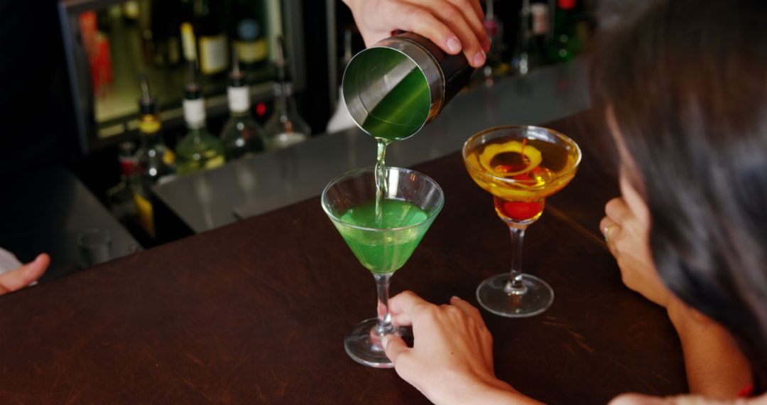 Bartender Preparing Colorful Cocktails at Bar - Free Images, Stock Photos and Pictures on Pikwizard.com