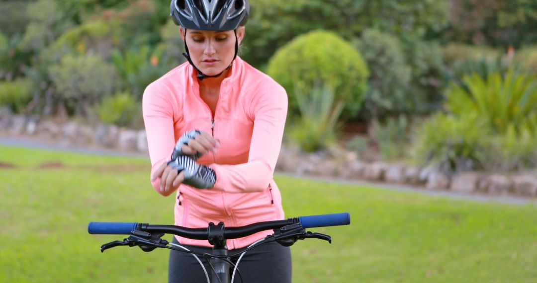 Woman Preparing for Cycling in Park with Protective Gear - Free Images, Stock Photos and Pictures on Pikwizard.com