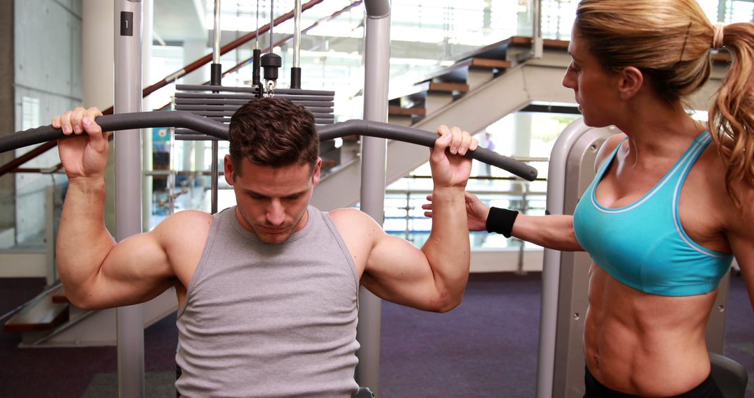 Fitness Instructor Assisting Man with Strength Training - Free Images, Stock Photos and Pictures on Pikwizard.com