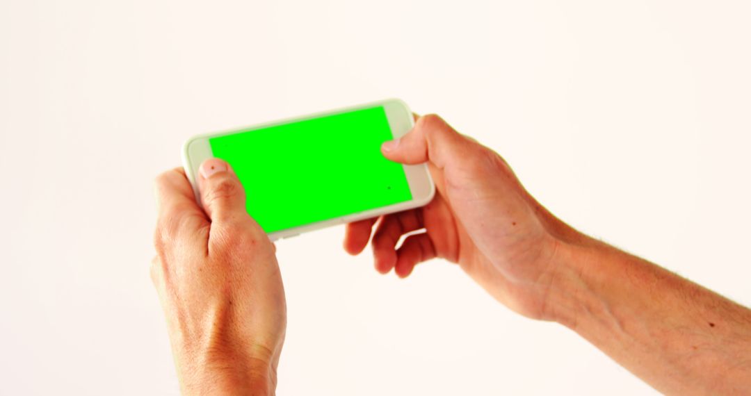 Hands Holding Smartphone With Green Screen for Mockup and Design Projects - Free Images, Stock Photos and Pictures on Pikwizard.com