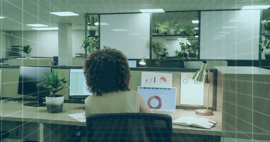 Desk View of Professional Analyzing Data on Laptop in Modern Office