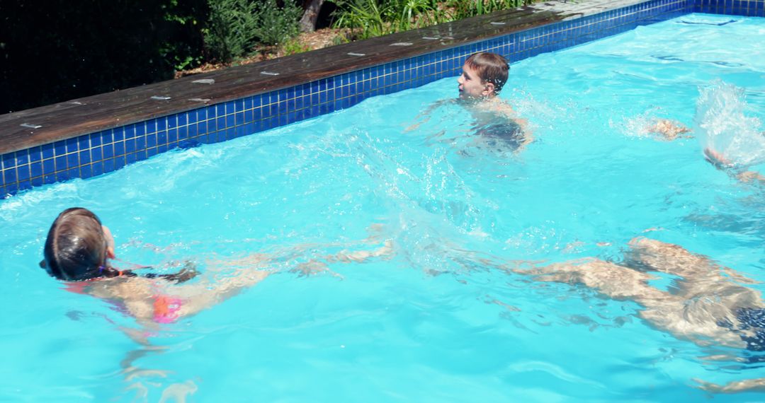 Children Enjoying Swimming and Splashing in Outdoor Pool - Free Images, Stock Photos and Pictures on Pikwizard.com