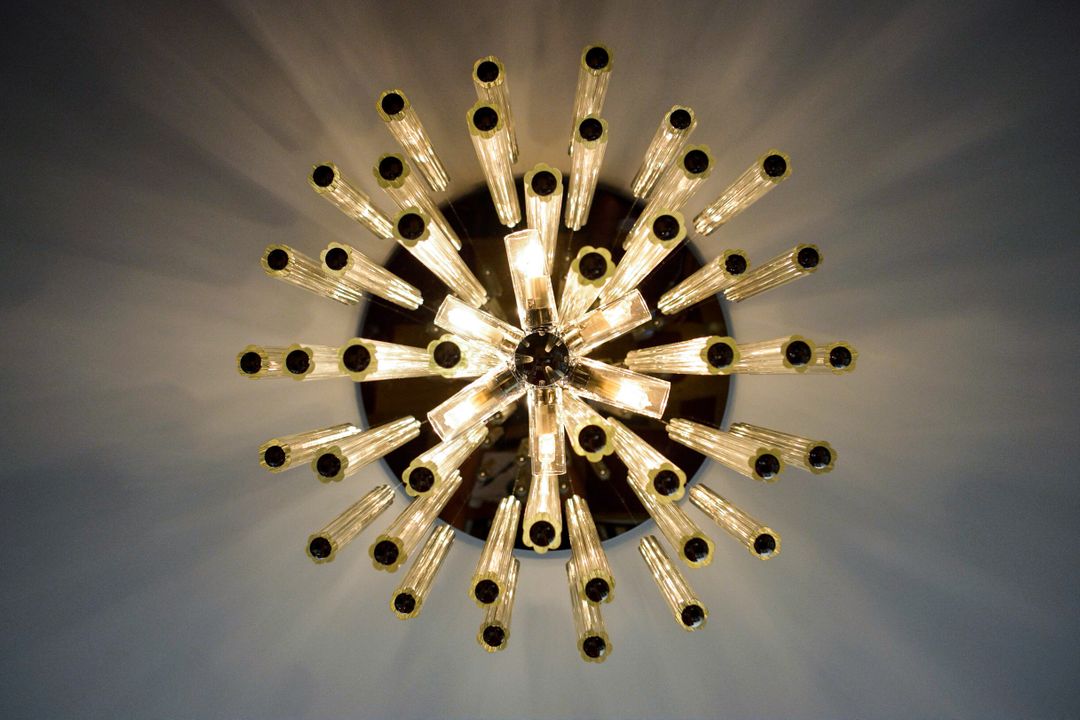 Modern chandelier with glowing light bulbs in various directions - Free Images, Stock Photos and Pictures on Pikwizard.com
