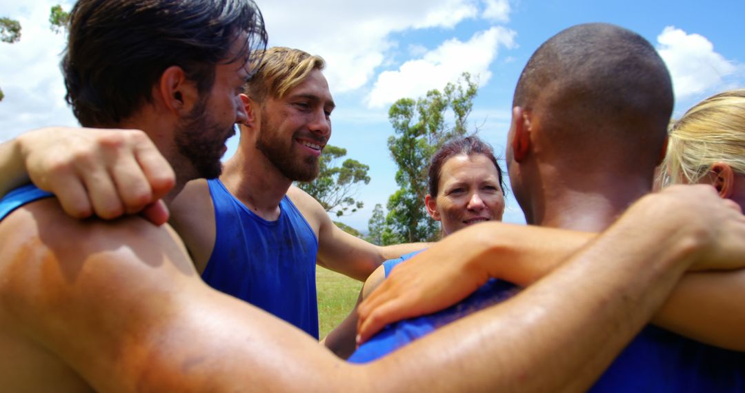 Diverse Team Huddled Together Outdoors Showing Unity