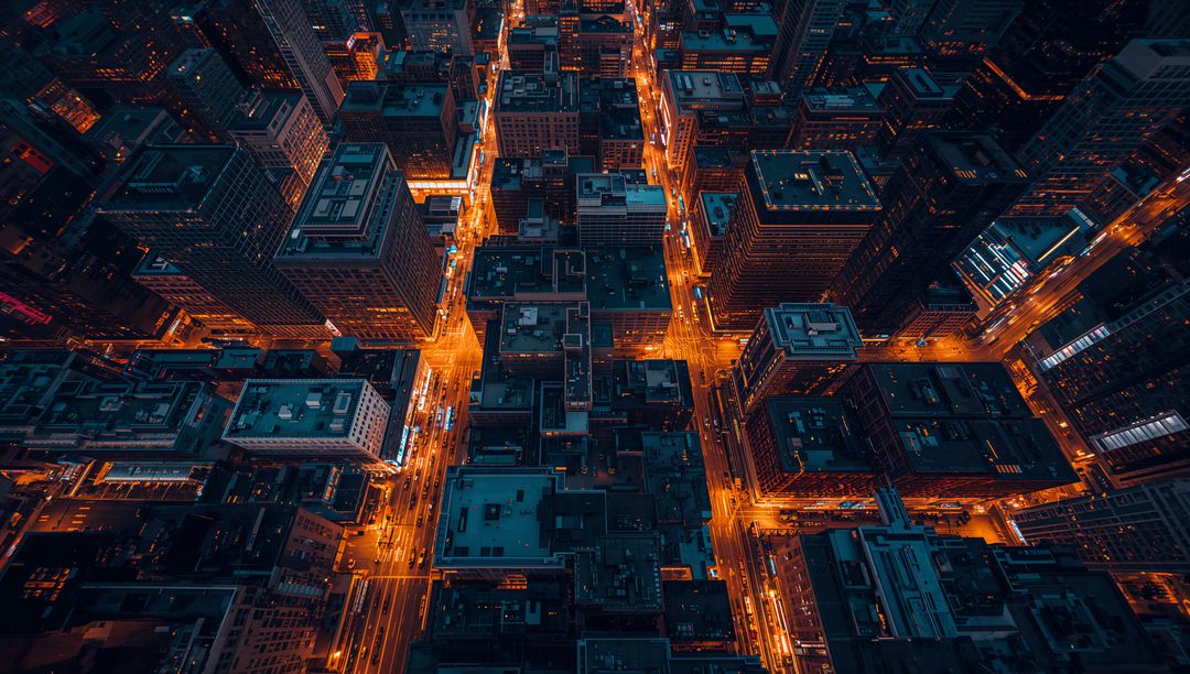 Downtown Grid Glowing at Night from Aerial Drone Showing Neon Traffic Trails