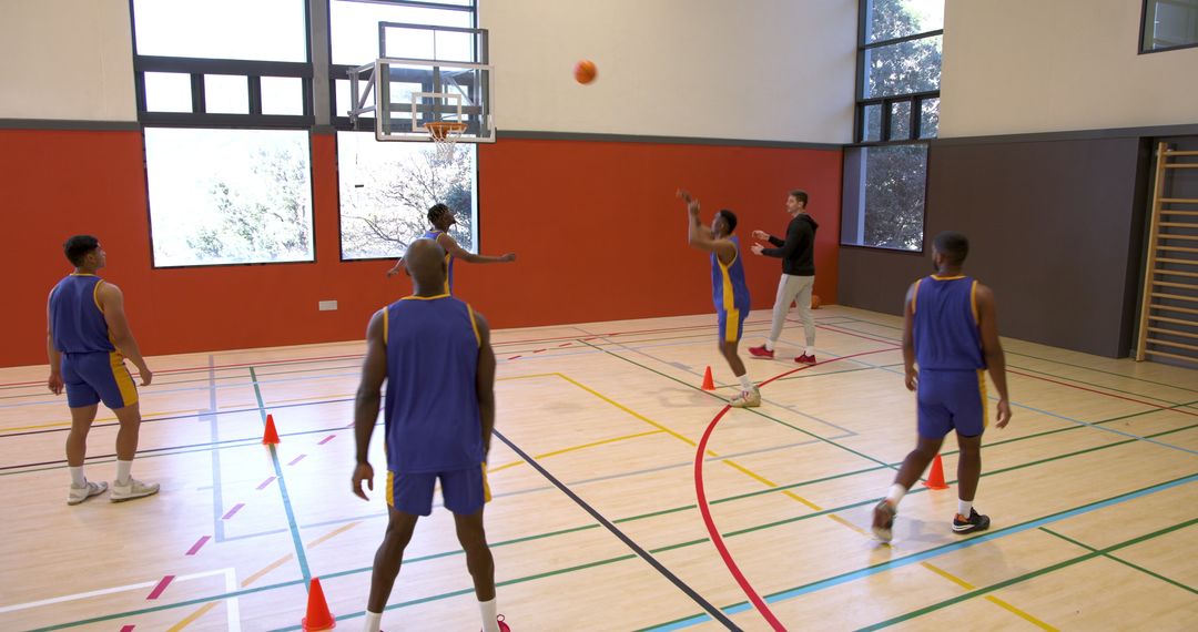 Basketball Team Practicing Drills in Gymnasium