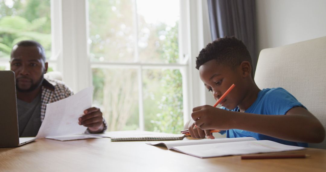 Father and Son Studying Together at Home