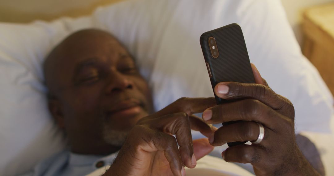 Senior Man Relaxing in Bed Using Smartphone at Night - Free Images, Stock Photos and Pictures on Pikwizard.com