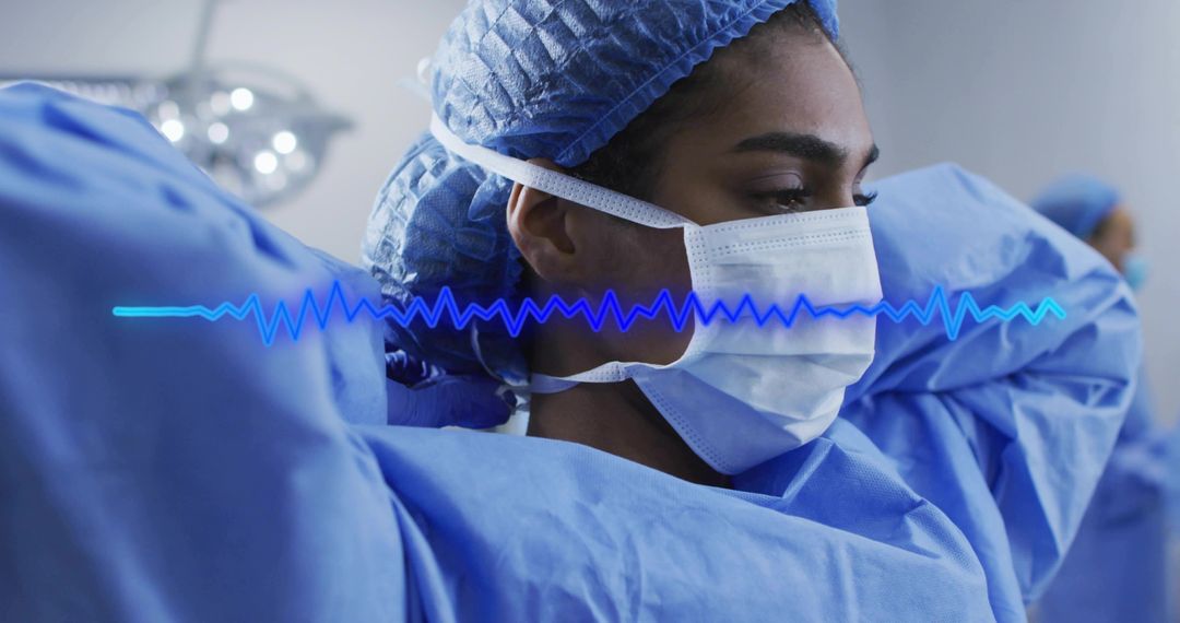 Surgeon Adjusting Mask Straps in Operating Room with Blue Scrubs and ECG Waveform Overlay