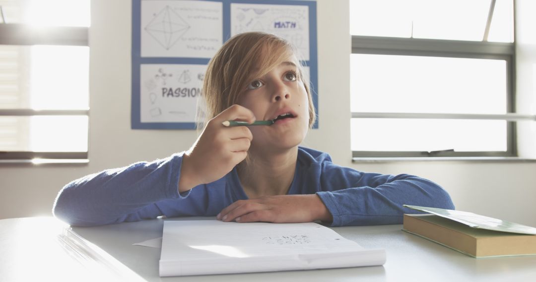 Thoughtful School Boy Engaging in Classroom Writing Activity