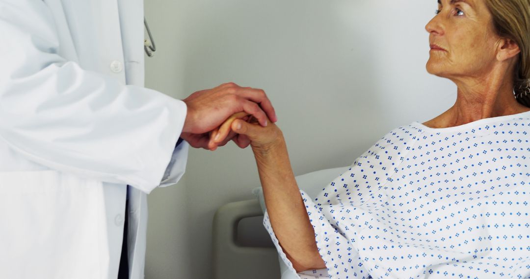 Doctor Holding Hands with Elderly Patient in Hospital - Free Images, Stock Photos and Pictures on Pikwizard.com