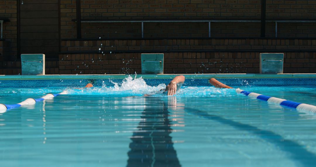 Swimmer Practicing Freestyle Stroke in Clear Blue Pool - Free Images, Stock Photos and Pictures on Pikwizard.com