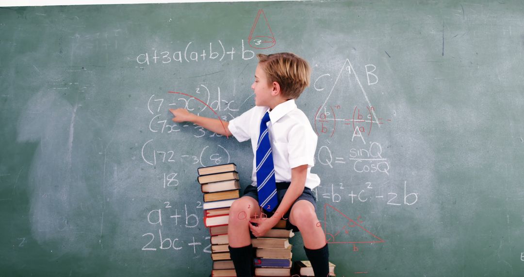 Young Student Solving Math Problems on Blackboard