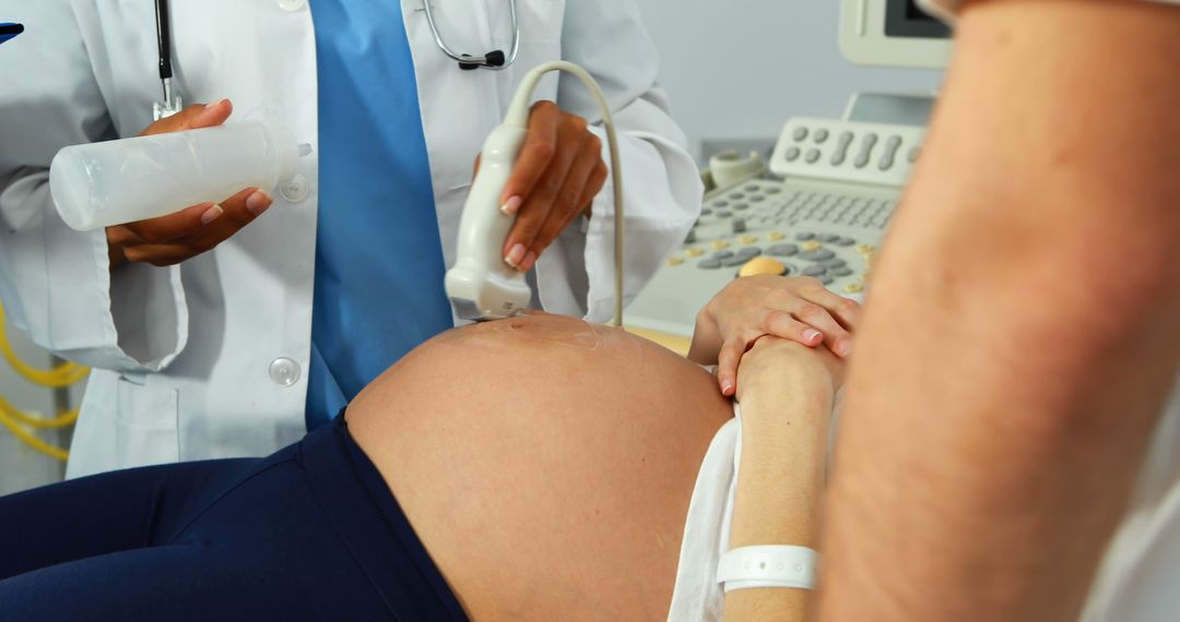 Doctor Performing Ultrasound Scan on Pregnant Woman at Clinic Setting - Free Images, Stock Photos and Pictures on Pikwizard.com