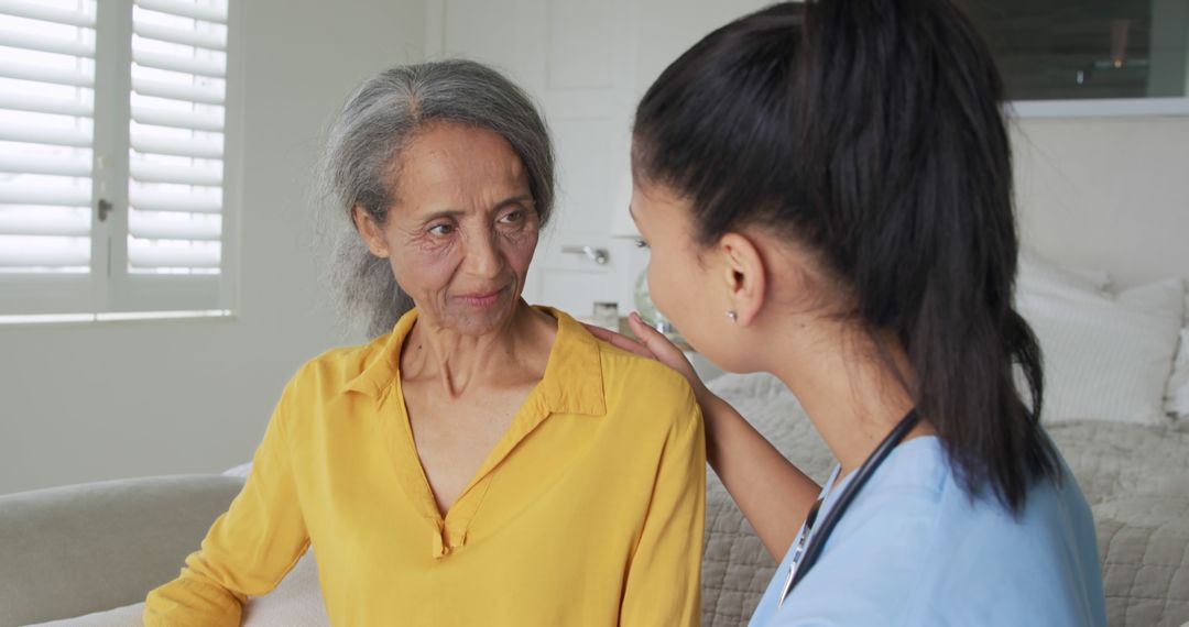 Nurse Offering Comforting Support to Elderly Woman at Home - Free Images, Stock Photos and Pictures on Pikwizard.com