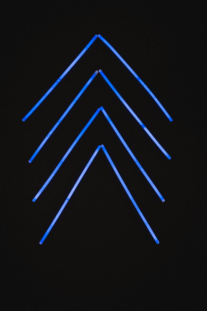 Illustration of illuminated blue neon arrows in a row against black background - Free Images, Stock Photos and Pictures on Pikwizard.com