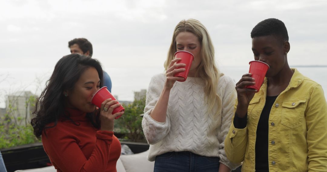 Friends Enjoying Outdoor Gathering with Red Cups - Free Images, Stock Photos and Pictures on Pikwizard.com