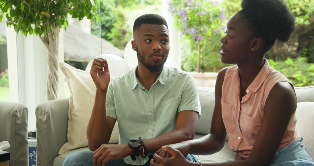 Couple Enjoying Conversation on Sofa at Home