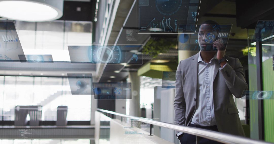 Executive talking on phone while leaning on glass railing with holographic interface overlays