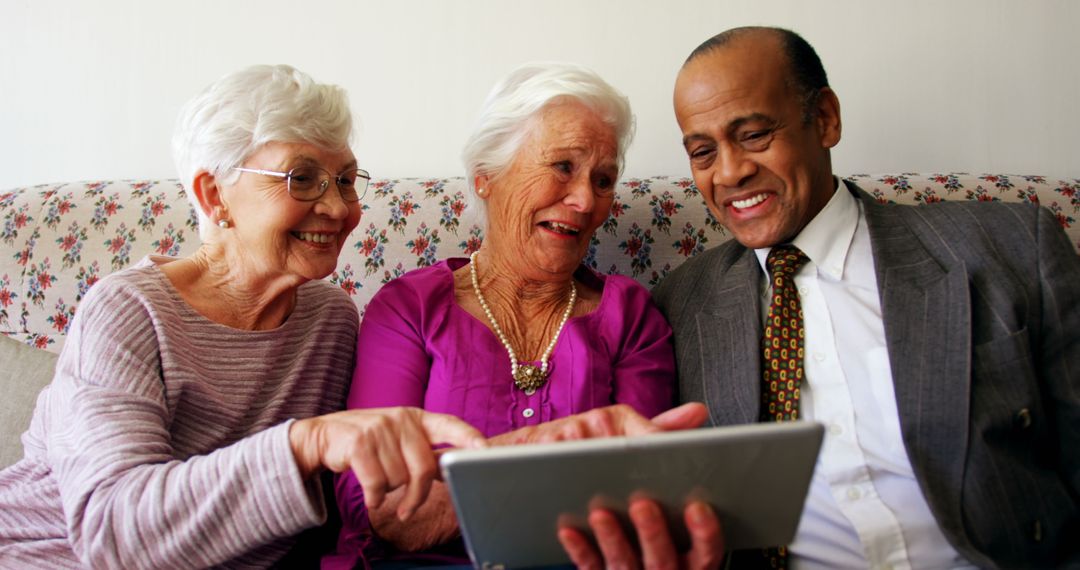Senior Diverse Friends Sharing Tablet Technology Experience