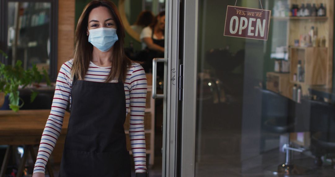 Smiling Hairdresser in Face Mask Welcoming Clients at Salon Entrance