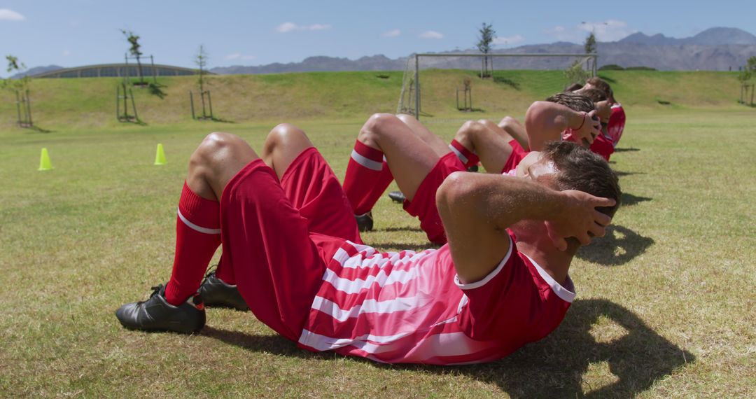 Soccer Players Doing Sit-Ups During Outdoor Training Session - Free Images, Stock Photos and Pictures on Pikwizard.com