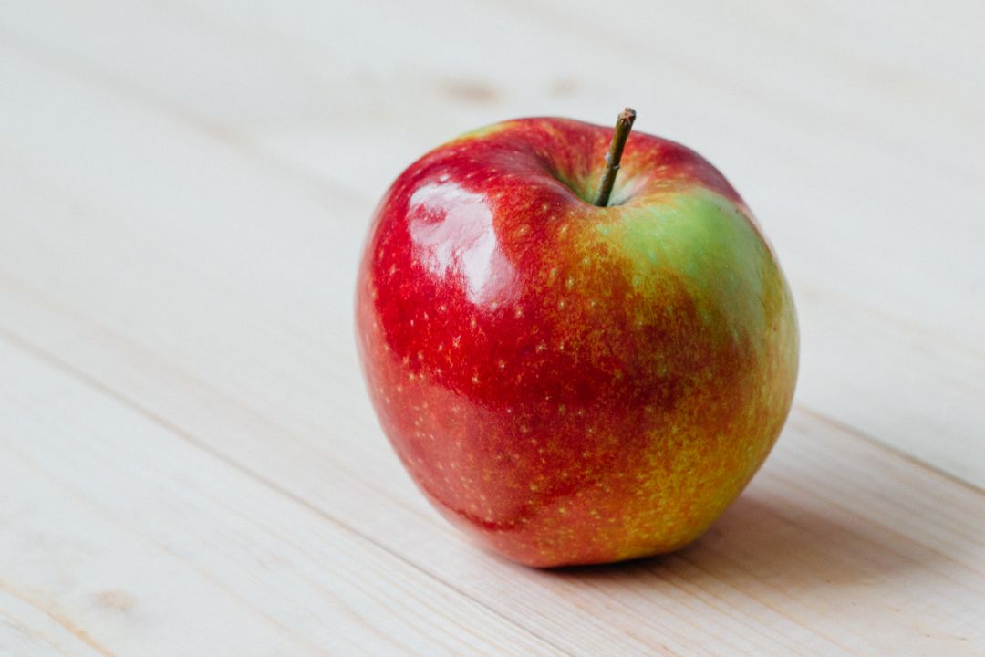 Single Fresh Red Apple on Light Wooden Surface - Free Images, Stock Photos and Pictures on Pikwizard.com