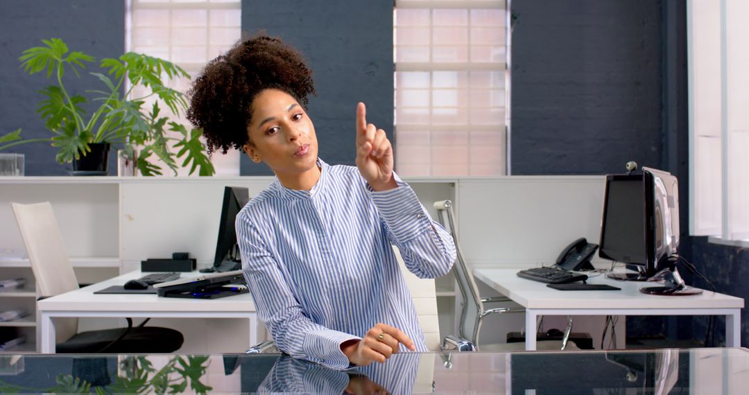 Businesswoman Confidently Presenting at Office Desk in Meeting