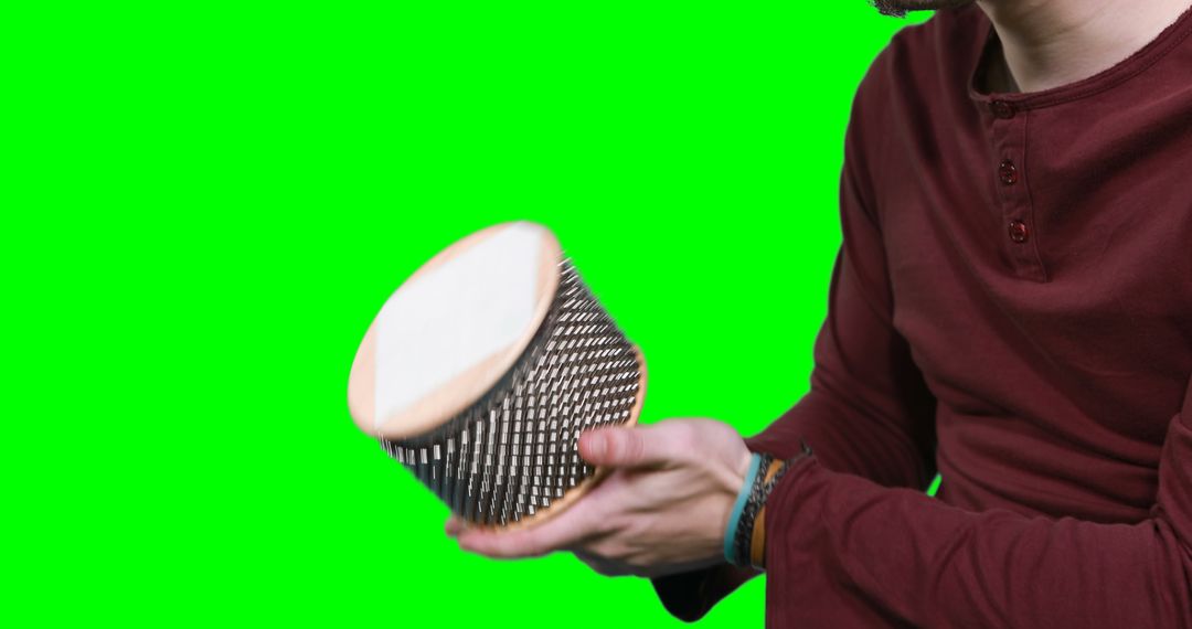 Man Playing Hand Drum Against Green Screen - Free Images, Stock Photos and Pictures on Pikwizard.com