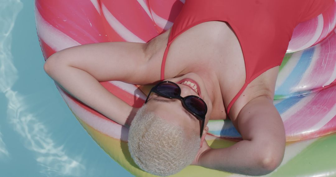 Relaxing Young Woman Lying on Inflatable in Pool on Sunny Day - Free Images, Stock Photos and Pictures on Pikwizard.com