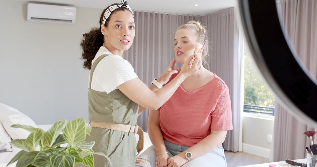 Makeup Artist Applying Foundation on Client in Bright Home Setting
