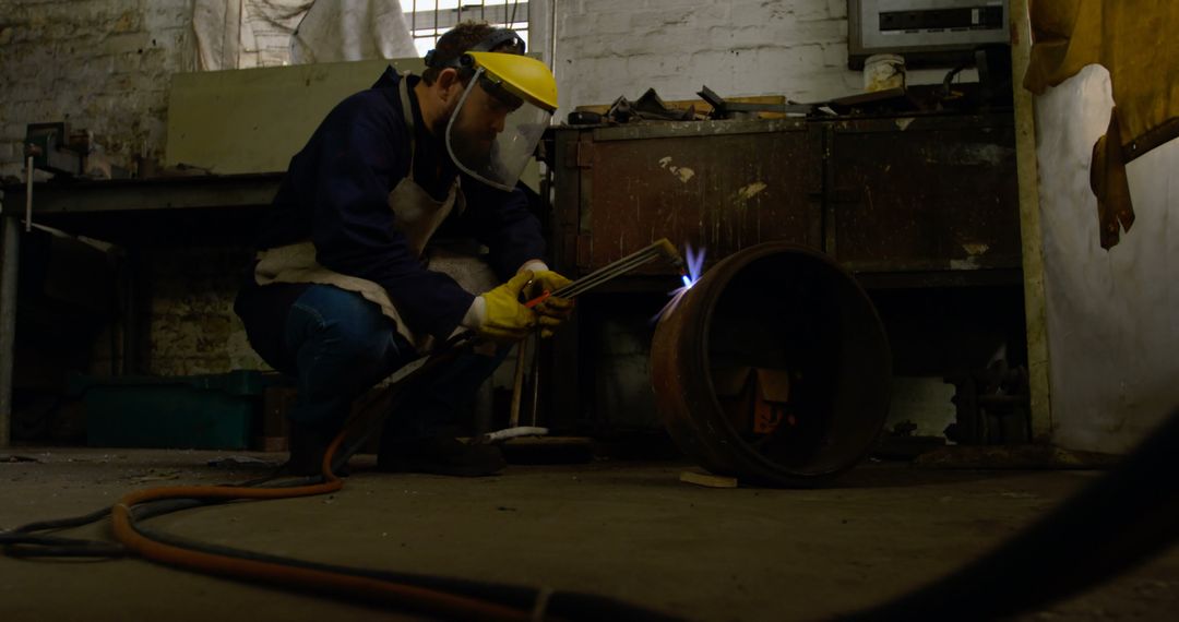 Welder in Protective Gear Working in Industrial Workshop - Free Images, Stock Photos and Pictures on Pikwizard.com