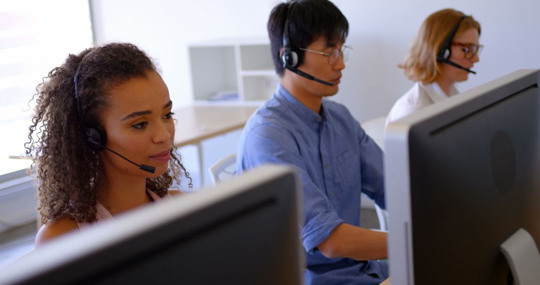 Customer Service Team Working at Desks in Modern Office