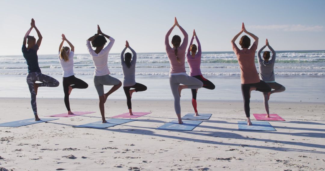 Group Yoga Session on Sunny Beach Practicing Tree Pose - Free Images, Stock Photos and Pictures on Pikwizard.com