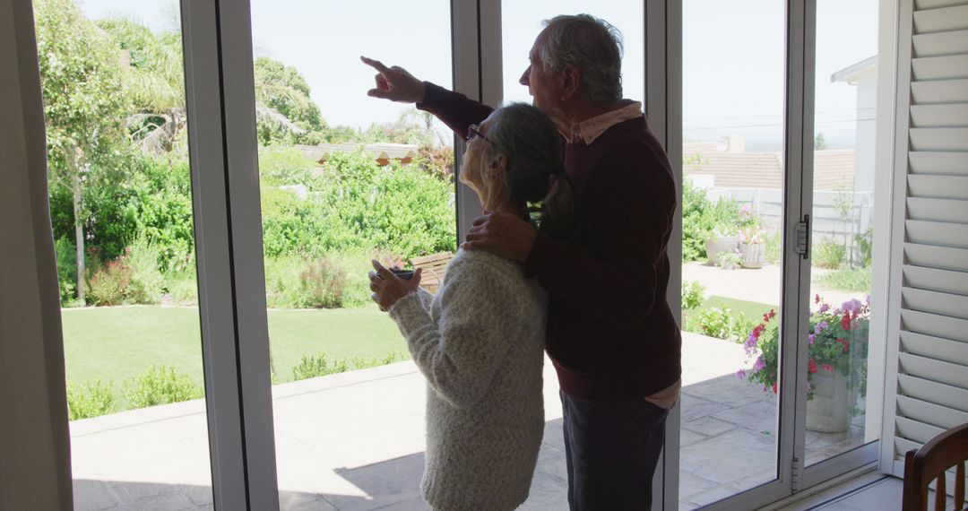 Senior Couple Relaxing by Window with Scenic Garden View