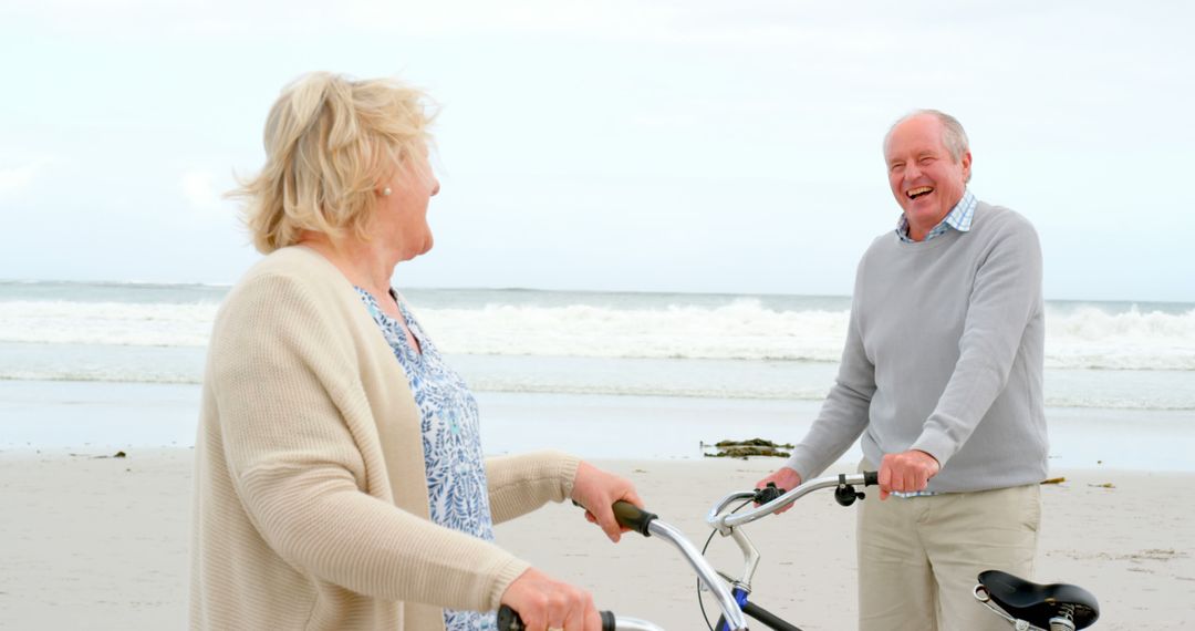 Senior couple by the beach with bicycles on a relaxed morning walk - Free Images, Stock Photos and Pictures on Pikwizard.com