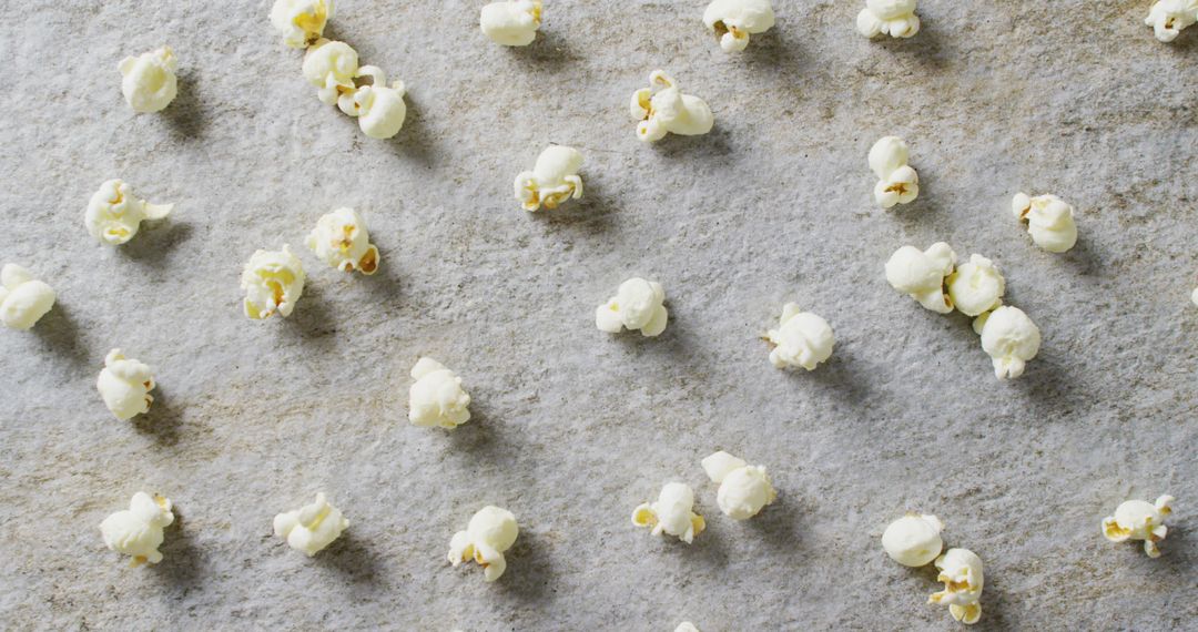 Scattered Popcorn on Gray Rustic Surface for Snack Background