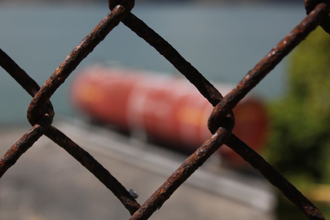 Rusty Chain Link Fence Overlooking Industrial Silos