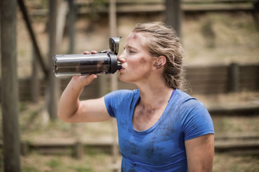 Woman Hydrating During Obstacle Course Training - Free Images, Stock Photos and Pictures on Pikwizard.com