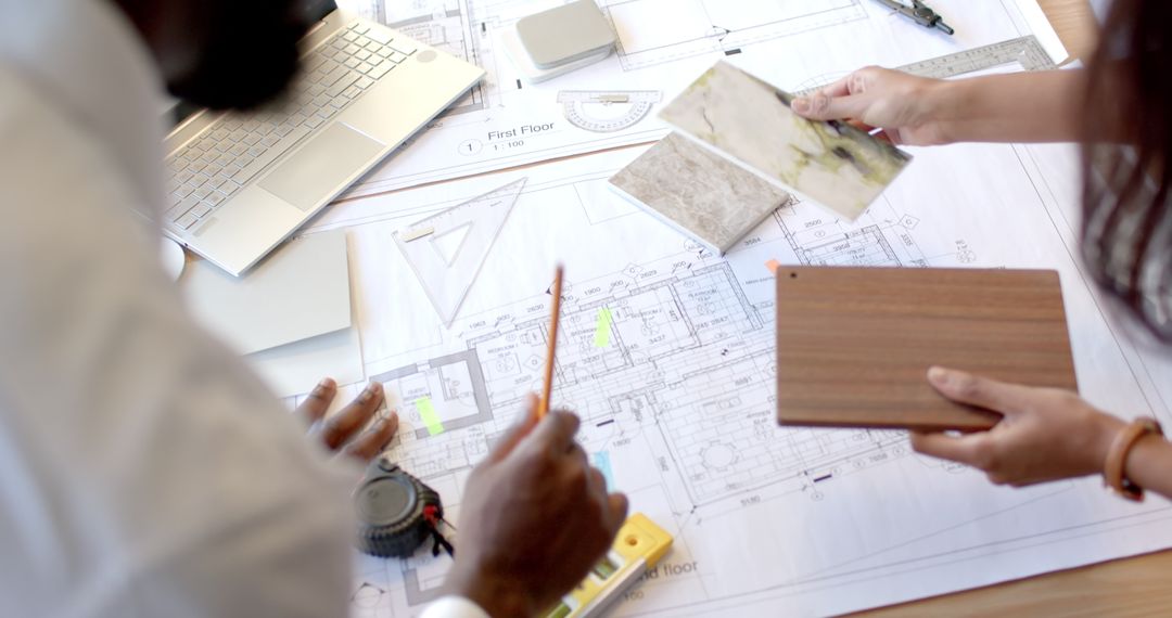 Colleagues Collaborating on Architectural Design Plans