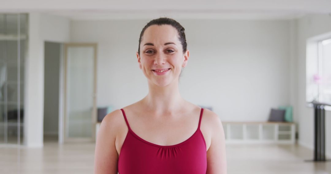 Smiling Ballet Dancer in Red Leotard at Studio