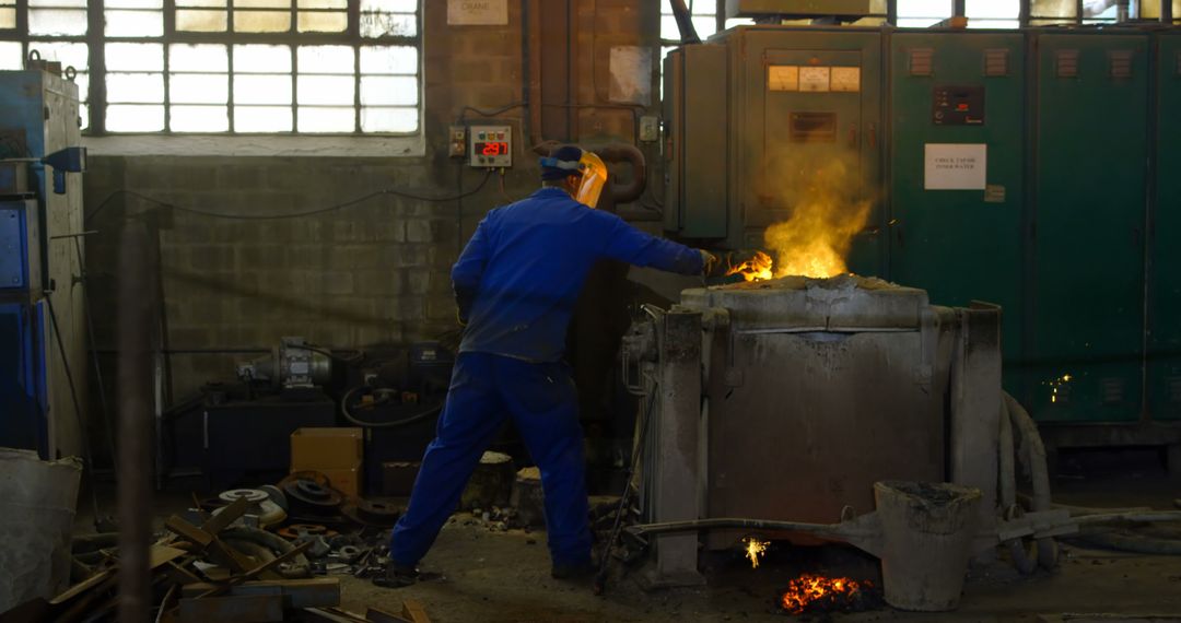 Factory Worker Operating Industrial Furnace in Foundry - Free Images, Stock Photos and Pictures on Pikwizard.com