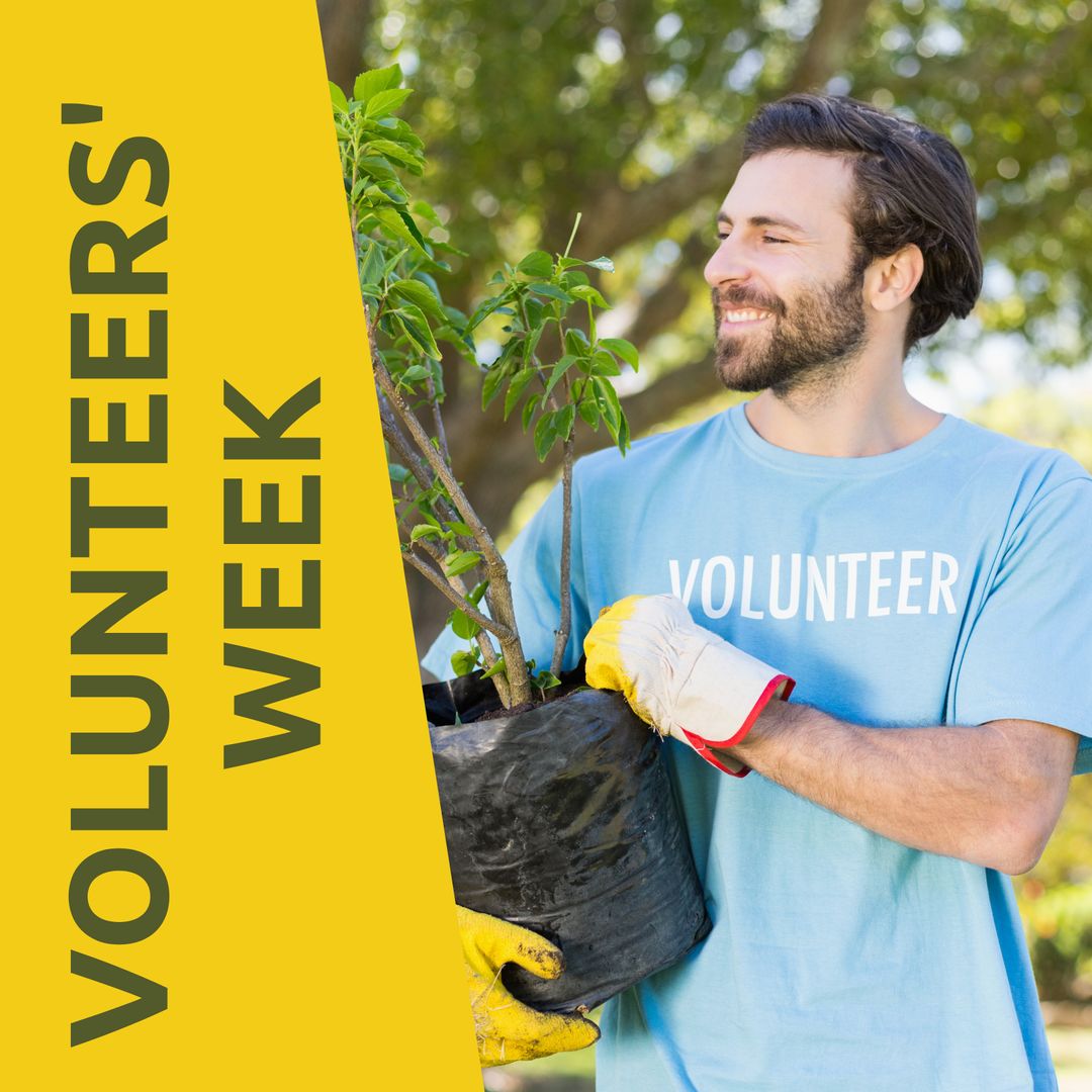 Smiling Volunteer Holding Tree During Campaign Event Outdoors