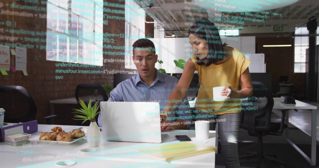 Colleagues Reviewing Code in Modern Open-Plan Office