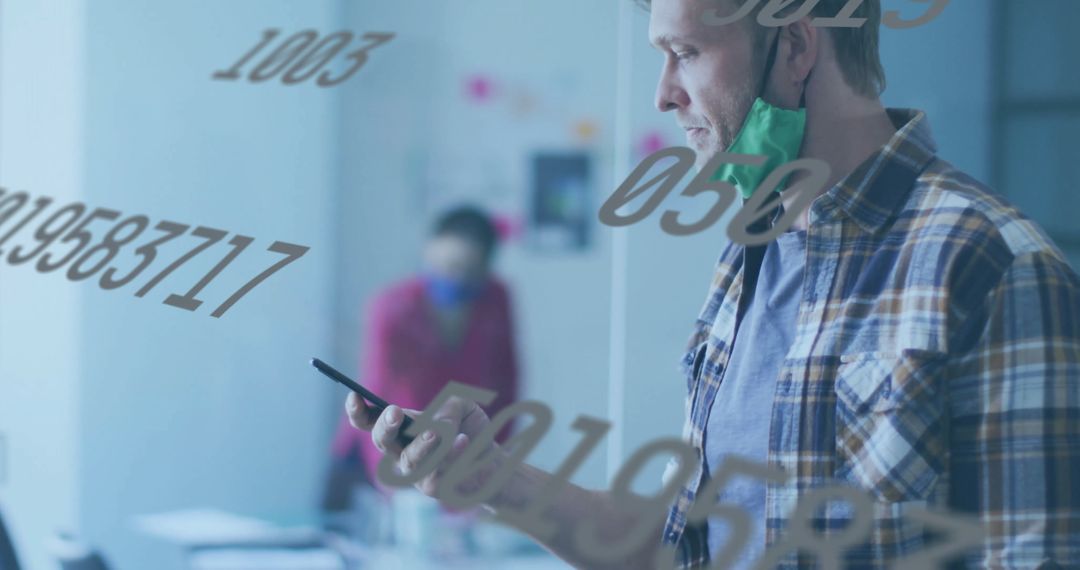 Man Standing Near Glass Wall with Numbers in Modern Office