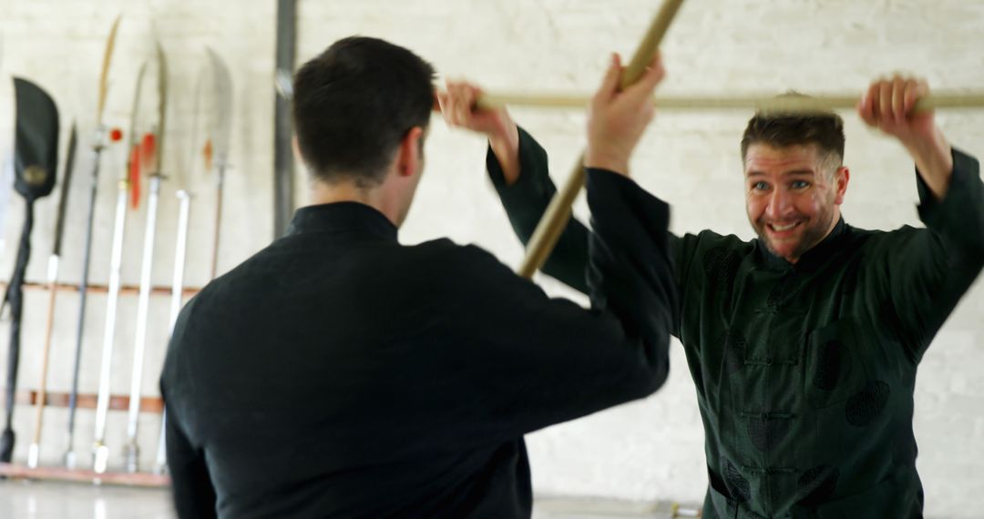 Two Men Practicing Martial Arts with Wooden Weapons - Free Images, Stock Photos and Pictures on Pikwizard.com