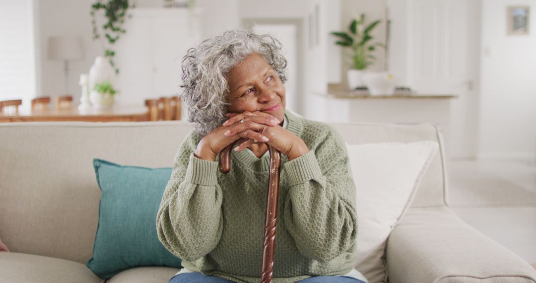 Smiling Senior Woman Relaxing on Couch at Home - Free Images, Stock Photos and Pictures on Pikwizard.com