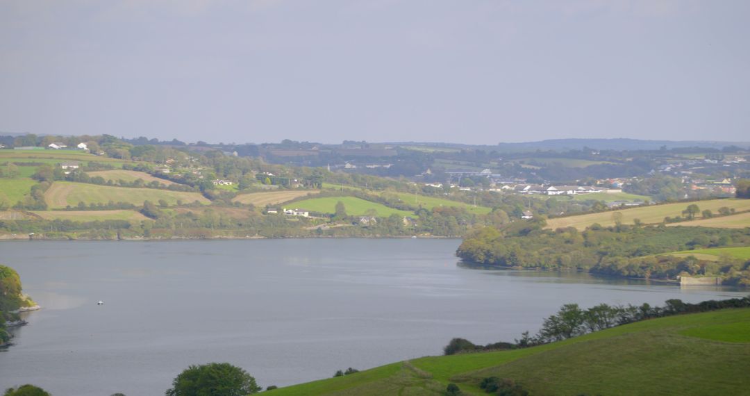 Scenic Landscape with Wide River and Lush Green Hills - Free Images, Stock Photos and Pictures on Pikwizard.com